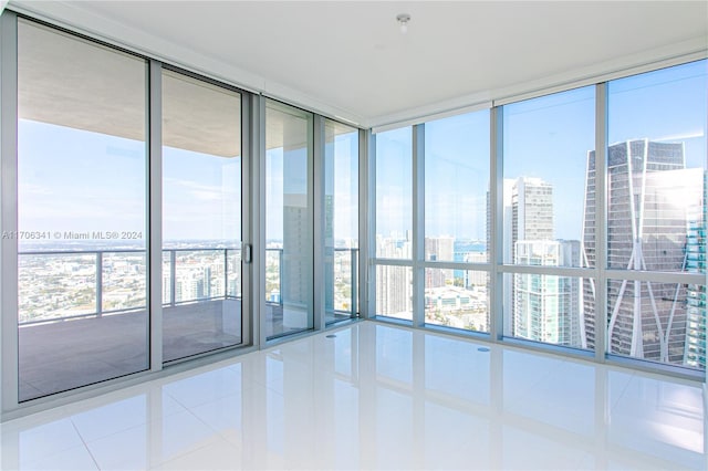 tiled spare room with floor to ceiling windows