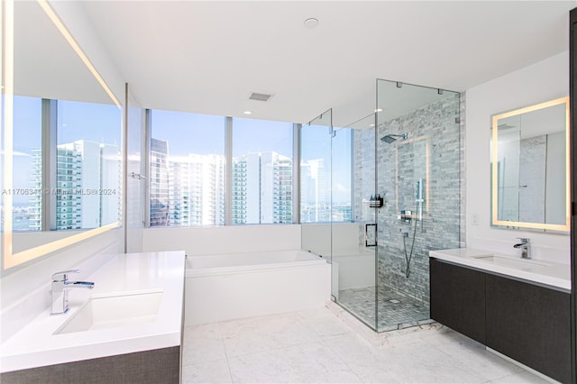 bathroom with tile patterned flooring, vanity, and separate shower and tub