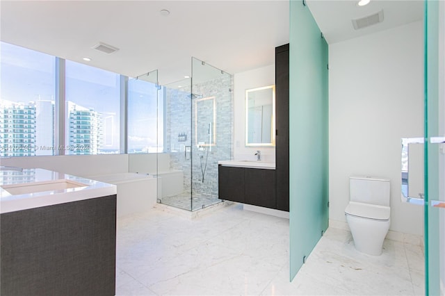 full bathroom featuring vanity, toilet, and independent shower and bath