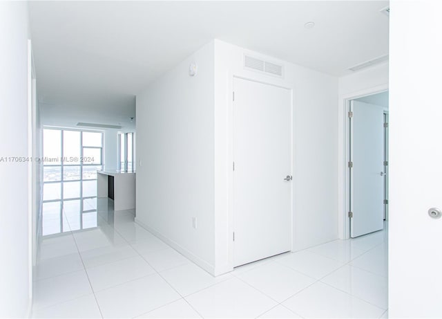 hall with light tile patterned flooring