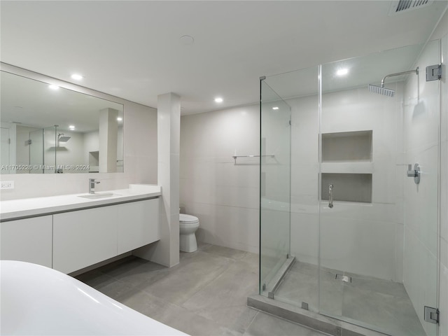 bathroom featuring toilet, vanity, and walk in shower