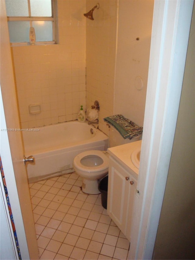 full bathroom featuring tile patterned flooring, vanity, toilet, and tiled shower / bath combo