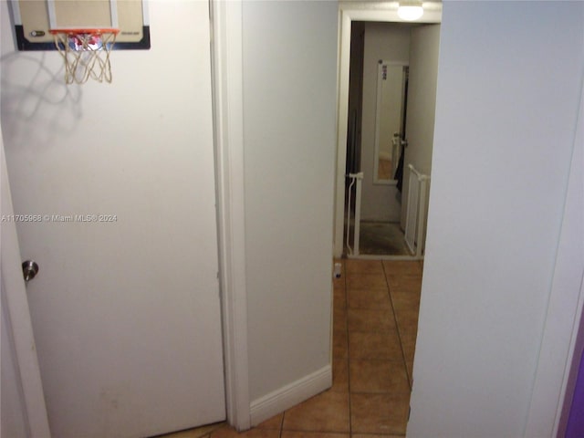 hallway featuring tile patterned flooring