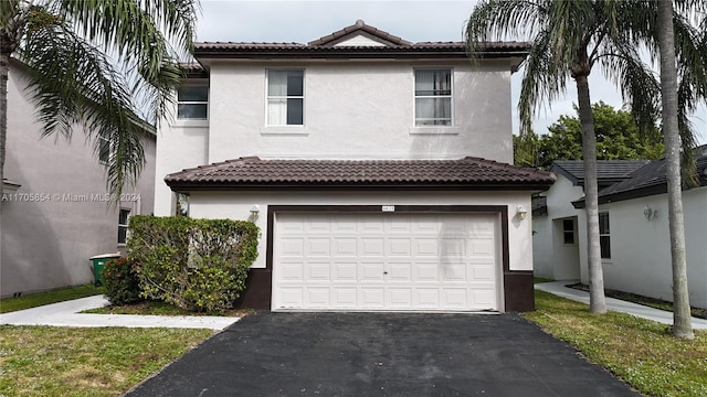 mediterranean / spanish home with a garage