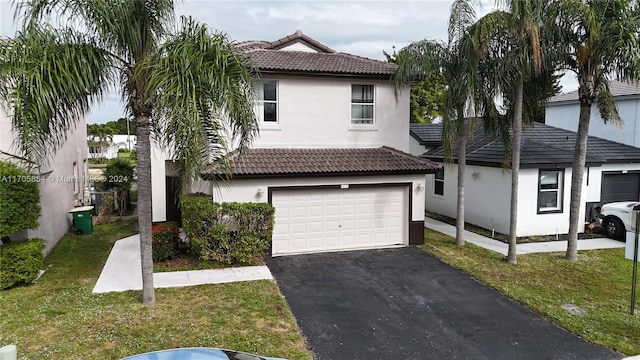 view of front of house with a front yard and a garage