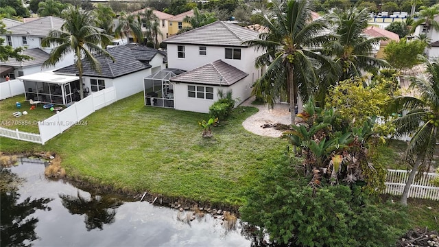 birds eye view of property with a water view