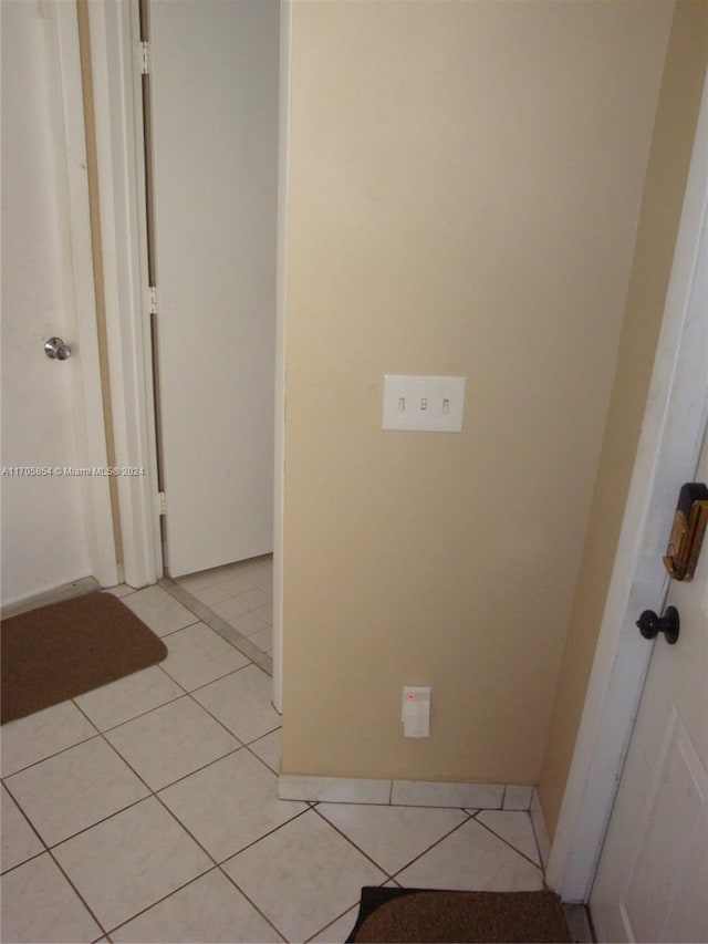 hall featuring light tile patterned flooring