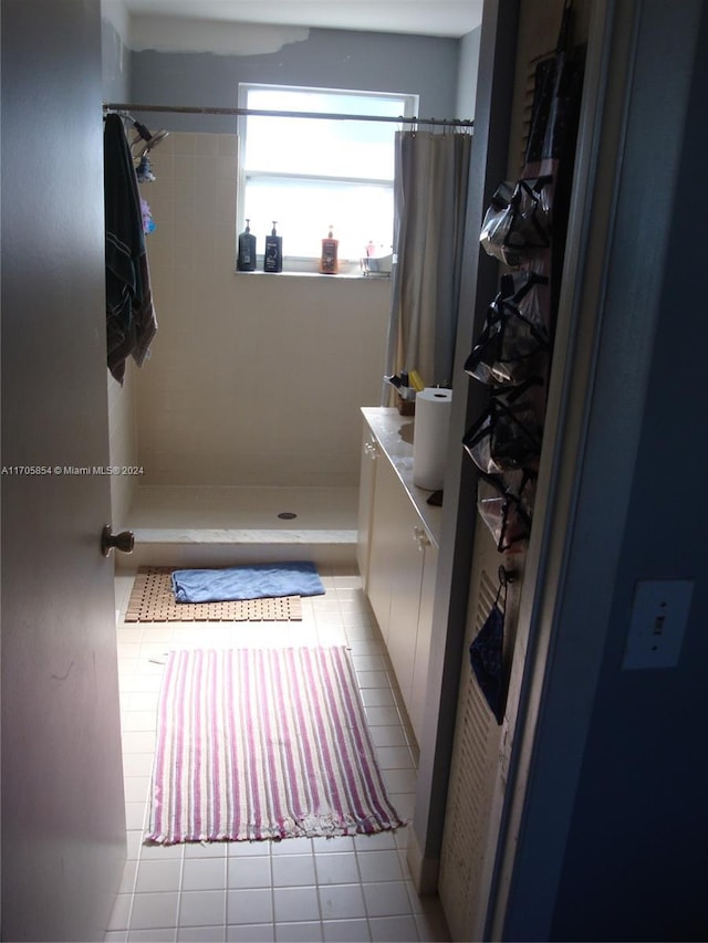 bathroom with a shower with shower curtain, vanity, and tile patterned floors