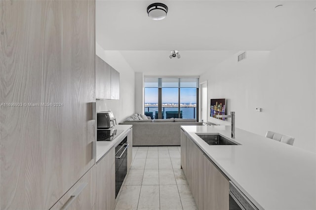 kitchen featuring black electric cooktop, sink, and oven