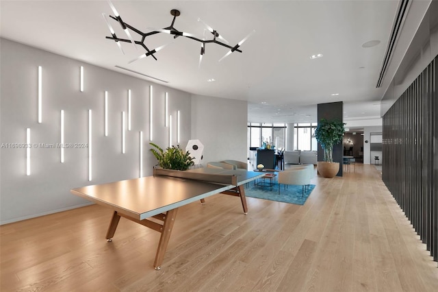 game room with light hardwood / wood-style flooring