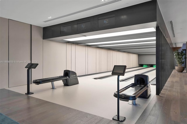 workout room with light hardwood / wood-style floors and a bowling alley