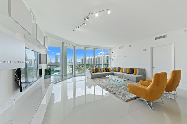 tiled living room with expansive windows and a healthy amount of sunlight