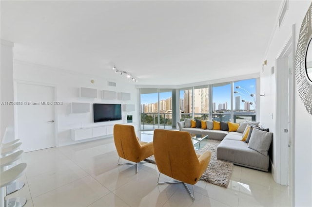 tiled living room with rail lighting, floor to ceiling windows, and crown molding