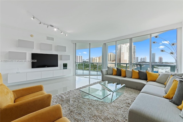 tiled living room featuring a wall of windows