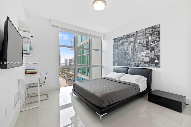 tiled bedroom featuring floor to ceiling windows