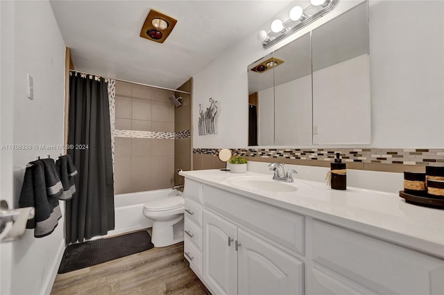 full bathroom featuring backsplash, hardwood / wood-style floors, shower / bathtub combination with curtain, and toilet