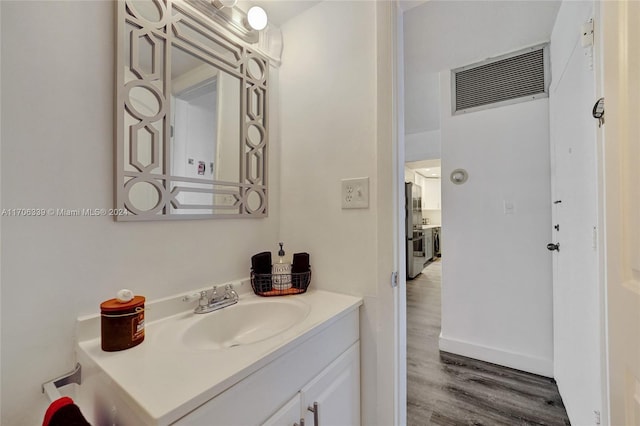 bathroom with vanity and wood-type flooring