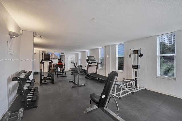 workout area featuring a textured ceiling