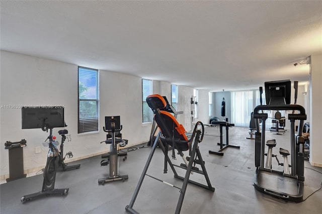 exercise room with a textured ceiling