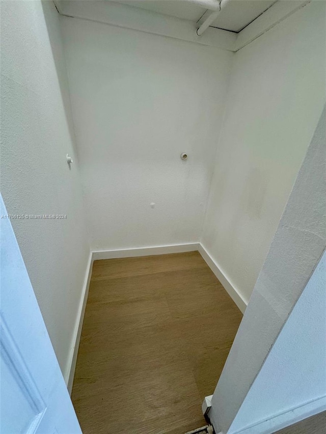 walk in closet with hardwood / wood-style flooring