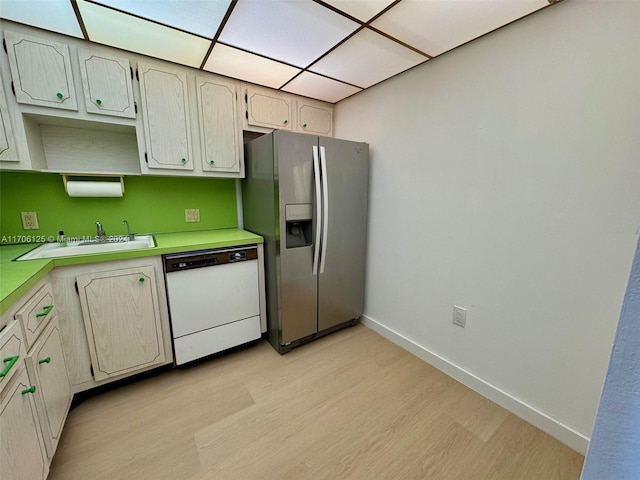 kitchen featuring white dishwasher, light hardwood / wood-style floors, stainless steel fridge with ice dispenser, and sink