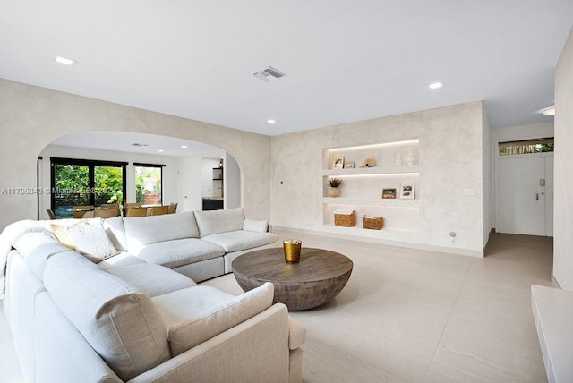 tiled living room featuring built in features