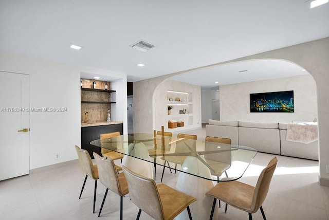 dining area featuring built in shelves and sink