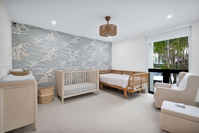 bedroom featuring a nursery area