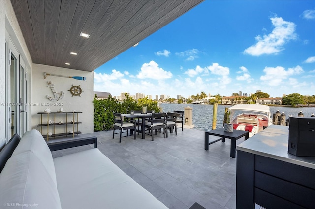 view of patio with an outdoor hangout area and a water view