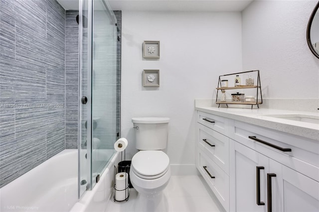 full bathroom with vanity, tile patterned floors, toilet, and combined bath / shower with glass door