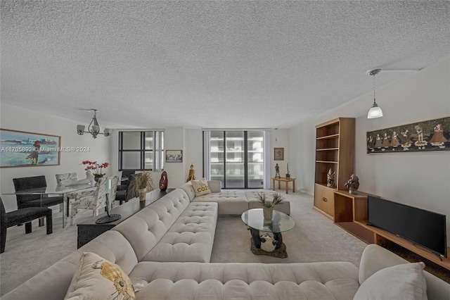 living room with carpet floors, a chandelier, and a textured ceiling