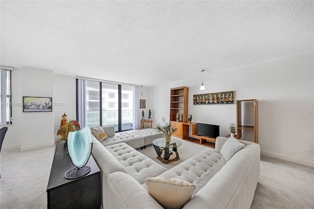 carpeted living room featuring a textured ceiling