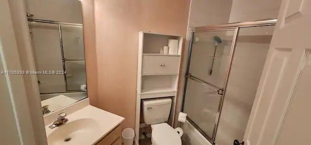 full bathroom featuring shower / bath combination with glass door, vanity, and toilet