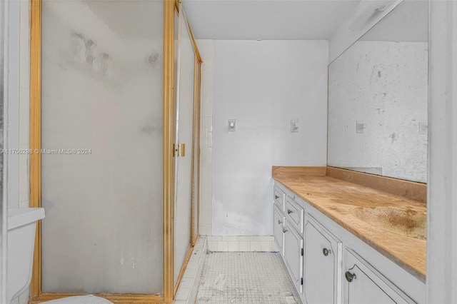 bathroom featuring vanity, tile patterned floors, and an enclosed shower