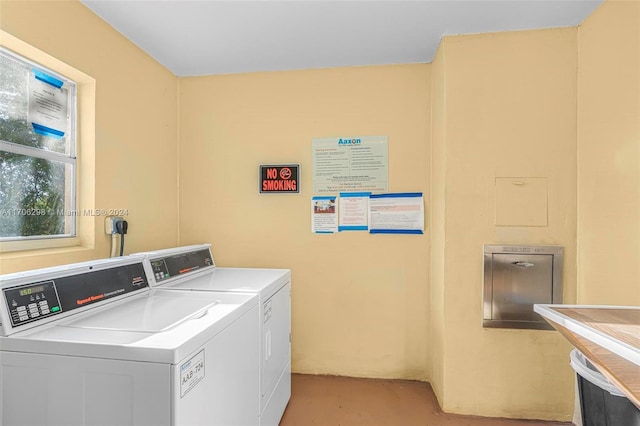 clothes washing area with washing machine and dryer