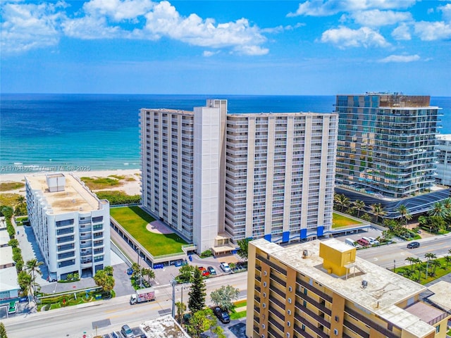 drone / aerial view featuring a beach view and a water view