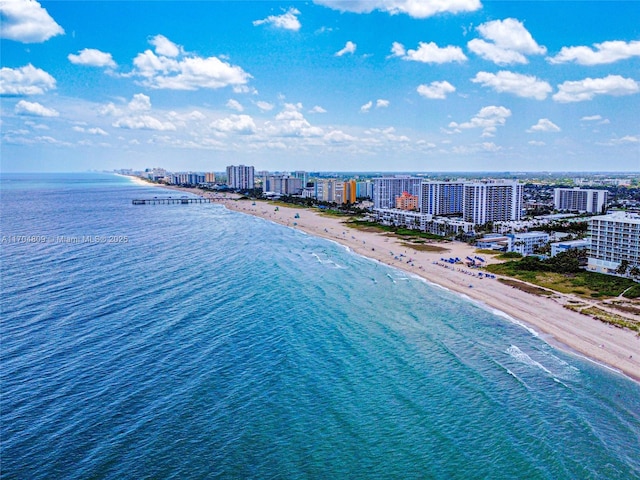 birds eye view of property with a beach view and a water view