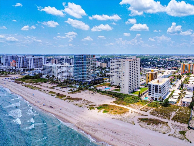 drone / aerial view with a water view and a beach view