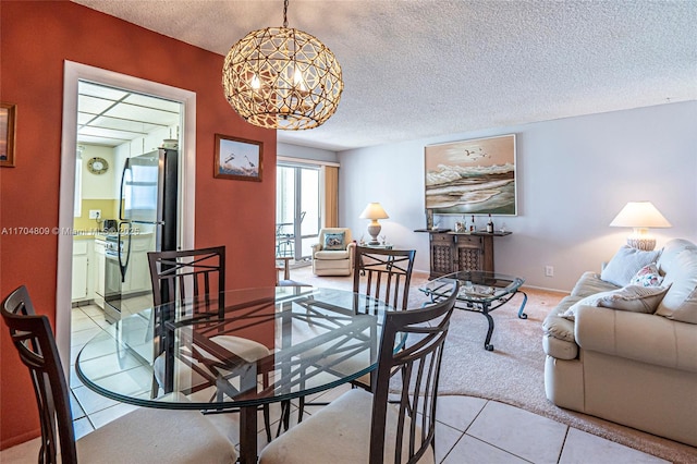 dining space with a textured ceiling and light tile patterned floors