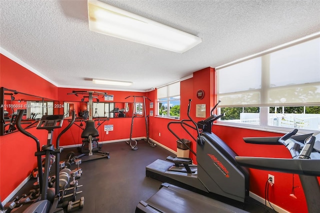 exercise room featuring a textured ceiling