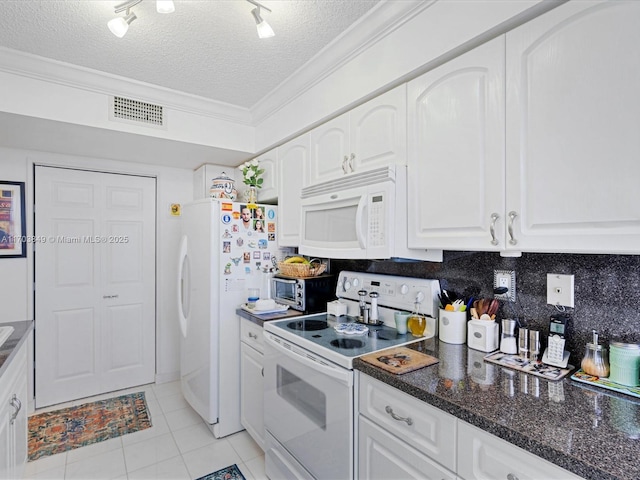 kitchen with decorative backsplash, white appliances, white cabinetry, and a textured ceiling