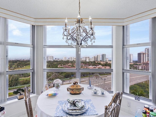 sunroom / solarium featuring an inviting chandelier and a healthy amount of sunlight