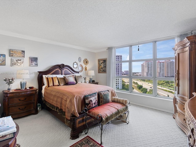 carpeted bedroom with a textured ceiling and crown molding