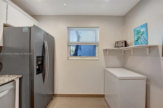 washroom with light tile patterned flooring