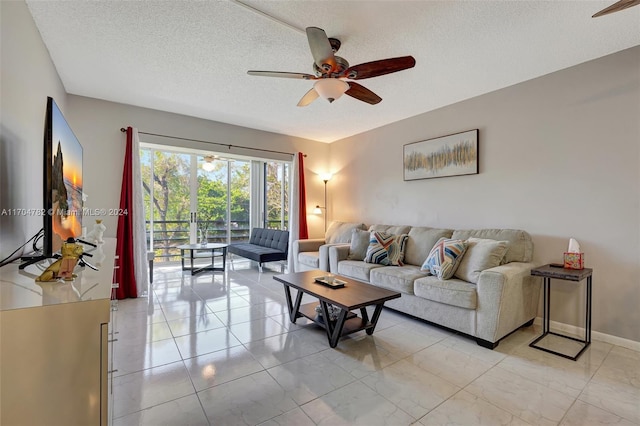 living room featuring a textured ceiling and ceiling fan