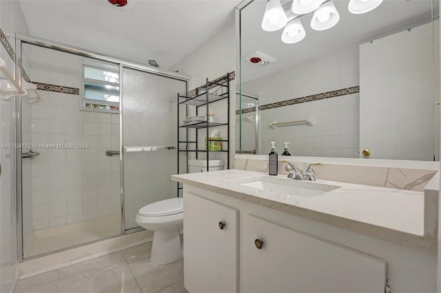 bathroom with walk in shower, vanity, and toilet