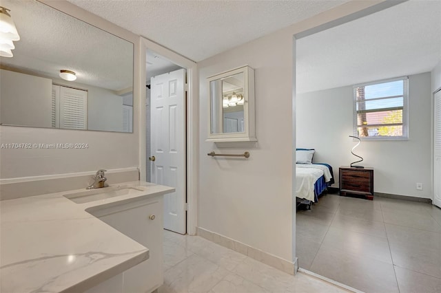 bathroom with vanity and a textured ceiling