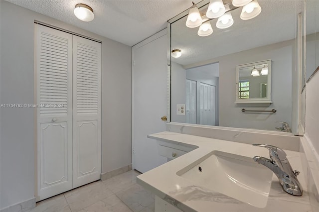 bathroom featuring vanity and a textured ceiling