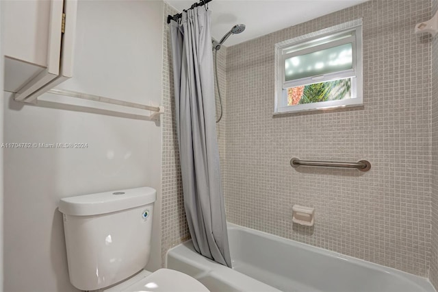 bathroom with shower / bath combo and toilet