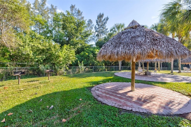 view of property's community featuring a yard and a patio area